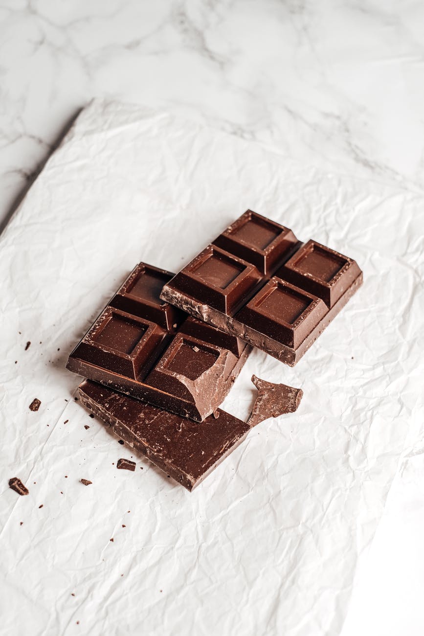 Chocolat noir comme aliment anti-stress sur papier blanc